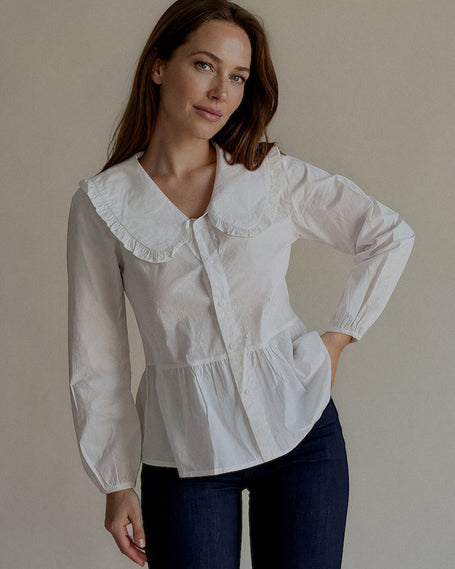 Chemise CÉLESTINE blanche à col Claudine brodé portée avec un jean brut